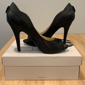 Black satin pumps with studded details